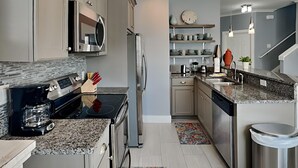 A modern kitchen with stainless steel appliances, granite countertops, and a built-in oven. - Runnin Down A Dream by Southern Vacation Rentals (Miramar Beach)