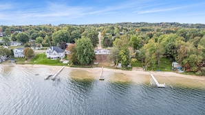 A lakeside property with a dock, a large house, and surrounding trees. - South Shore Bear Lake Family Cottage (Bear Lake)