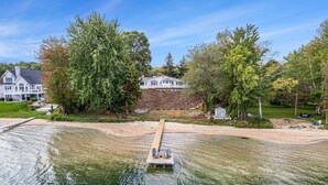 A lakeside property with a dock, a large house, and a well-maintained lawn. - South Shore Bear Lake Family Cottage (Bear Lake)