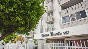 A building with balconies and a sign reading "Ocean Tower 557". - OT7-3 bedrooms near to everything (Carolina)