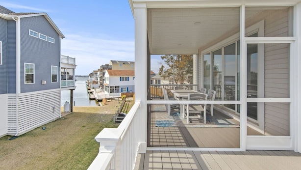 A residential property with a covered patio, a view of the water, and a neighboring house. - Fenwick on Bay mins to beach. Hot tub, Game Rm! (Selbyville)