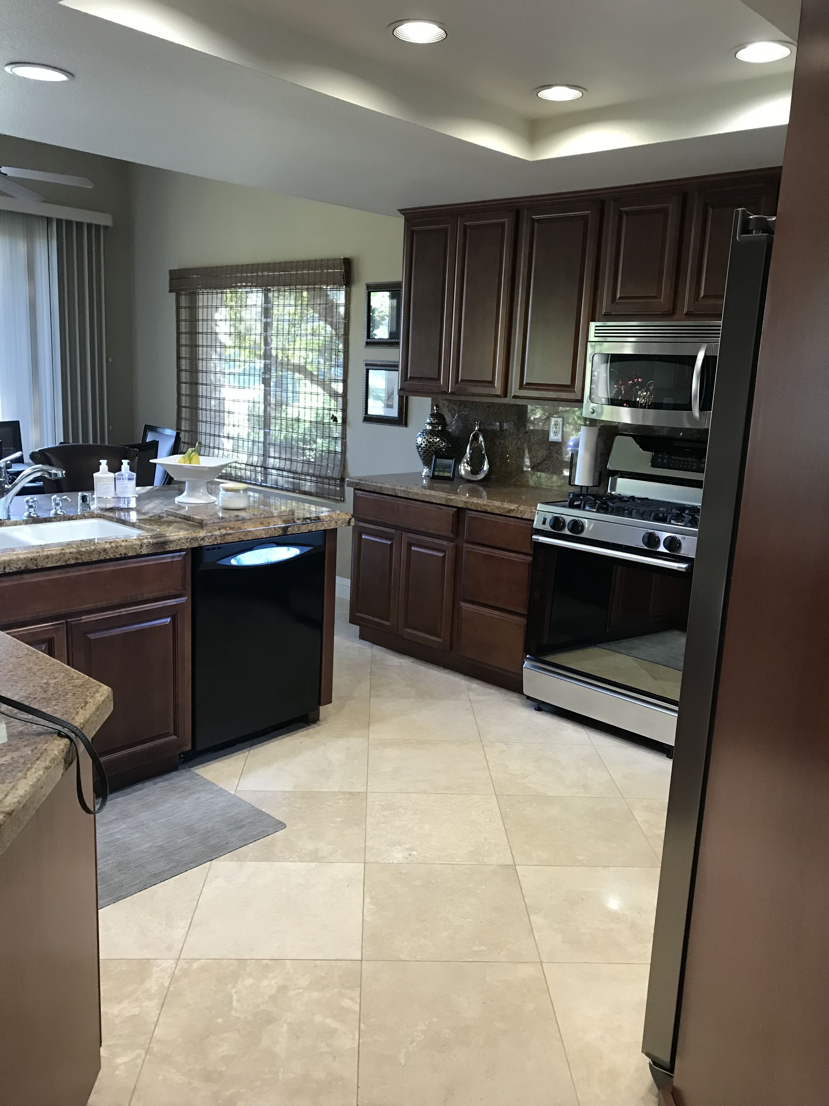 A modern kitchen with a dishwasher, stove, and microwave.