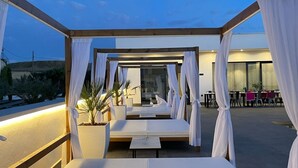 A rooftop lounge with white canopies, cushioned seating, and potted plants. - Villalemar Alojamiento Rural 5 Estrellas (Urda)
