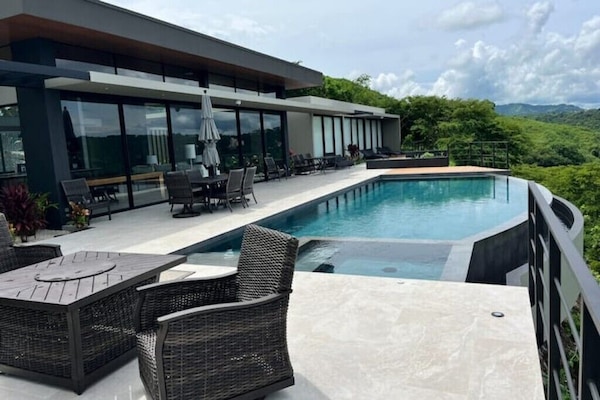 Enjoy this gorgeous infinity pool with plenty of seating & lounge chairs