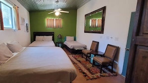 A room with two beds, a desk, a chair, a ceiling fan, and a mirror. - Boutique Hillside Hotel with Breathtaking Vistas. BBQ, Hiking Trail & Dark Skies (Oracle)