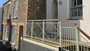 A two-story building with a stone facade and a white upper level. - No 1 -  an apartment that sleeps 2 guests  in 1 bedroom (St Mawes)