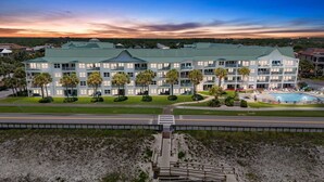 A multi-story hotel with a green roof, a pool, and a beach access walkway. - Maravilla 1201 3/2 pet friendly second floor unit beach service (Miramar Beach)