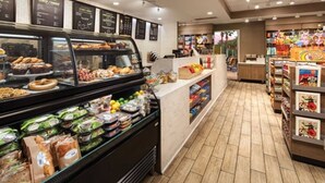 A bakery counter with various baked goods and a deli section with packaged salads and sandwiches.