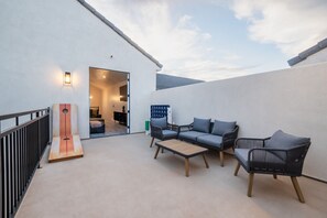 An outdoor seating area with a sofa, chairs, and a table. - Large 5 bedroom with double bunkroom and pool (Hurricane)