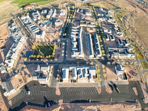 An aerial view of a residential area with multiple buildings, roads, and a parking lot. - Great Outdoor Space, Games, Mins from Lake (Hurricane)