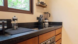 Coffee/tea maker, fridge, stovetop, cookware/dishes/utensils