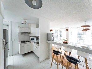 Fridge, microwave, stovetop, coffee/tea maker