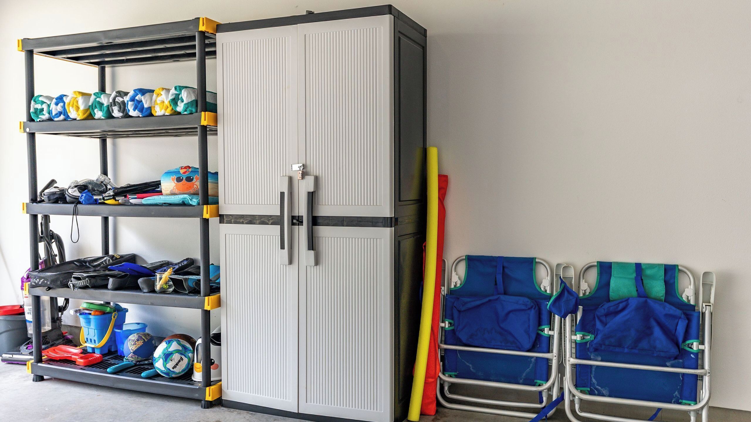 A storage unit with shelves, a cabinet, and two wheelchair-accessible chairs.