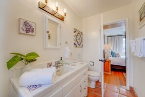 A bathroom with a white sink, a mirror, a toilet, and a shower area. - South Mission Beach Duo! Rent 2 units together! (San Diego)