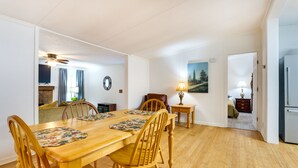 A dining area with a wooden table and chairs, a ceiling fan, and a painting on the wall. - 1 Mi to Lake Allatoona: Family Home on Farm! (Acworth)