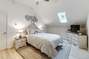 A bedroom with a bed, nightstand, dresser, and a skylight. - 2 Mi to Bethany Beach! Family Home w/ Deck (Frankford)