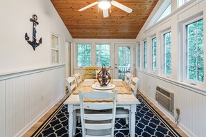 A dining area with a wooden ceiling, white walls, and large windows. - 2 Mi to Bethany Beach! Family Home w/ Deck (Frankford)