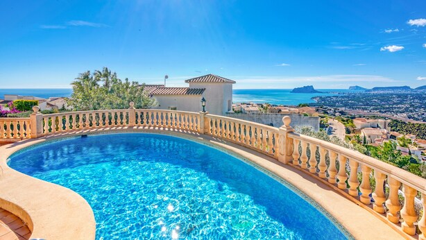 A curved swimming pool with a balustrade, surrounded by a fence, overlooking a coastal town and the sea. - Villa 'Casasilma' with Sea View, Wi-Fi and Air Conditioning (POBLE NOU DE BENITATXELL)
