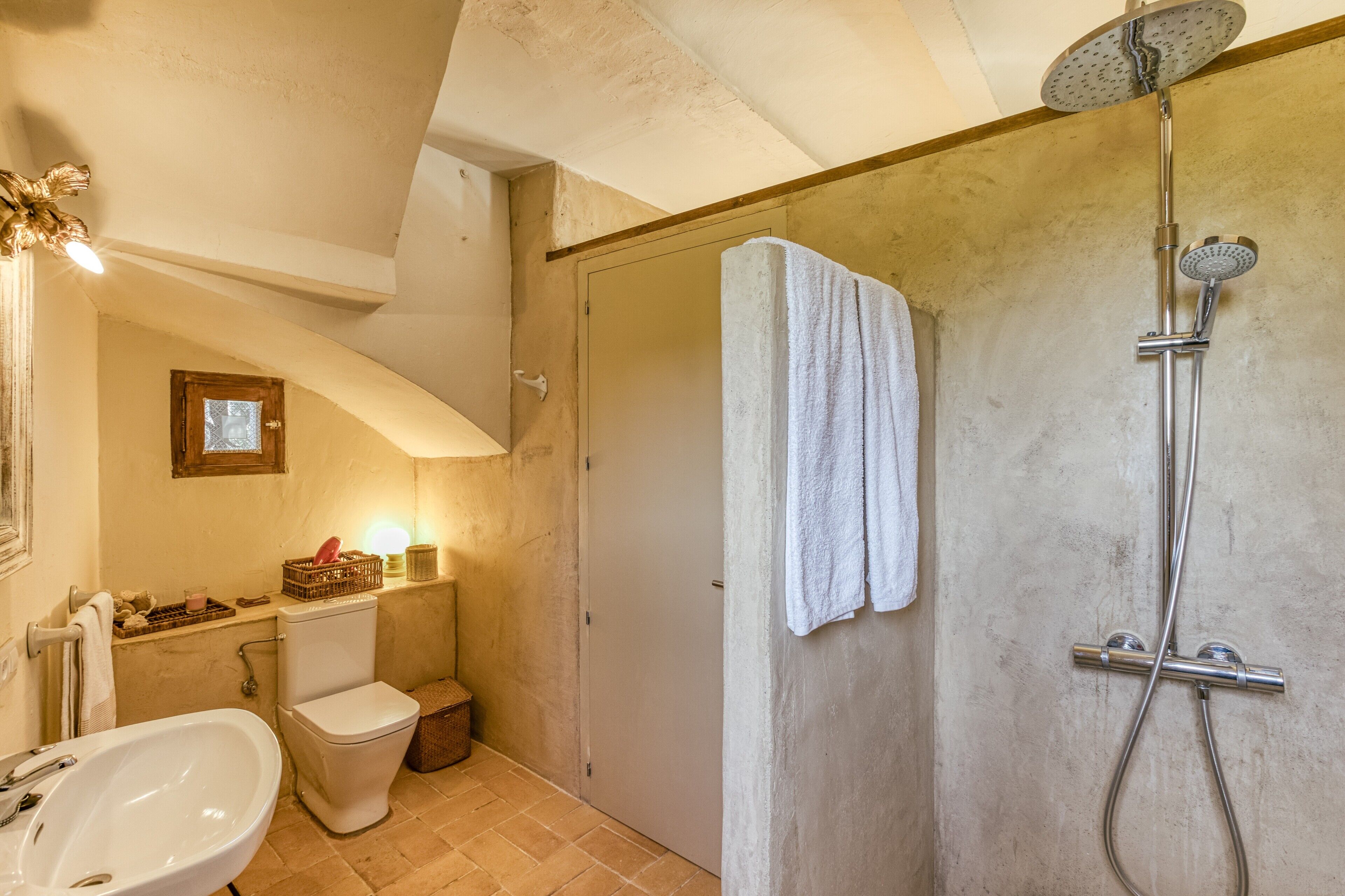 Ein Badezimmer mit Dusche, Toilette, Waschbecken und einem Handtuch an der Wand.
