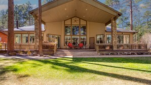 A two-story house with a covered porch, stone pillars, and large windows. - Luxury Family Retreat w/ Views, Golf: Fore Seasons (Pinetop)