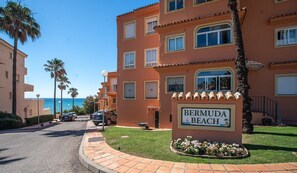A multi-story hotel with a sign reading 'Bermuda Beach.'