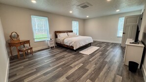 A bedroom with a wooden bed, a nightstand, a dresser, and a chair. - Close to everything-tucked away from the noise. A brand-new, blissful stay. (Ithaca)