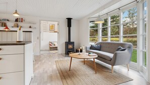 A modern living room with a sofa, a coffee table, and a fireplace.