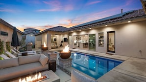 A backyard with a swimming pool, outdoor seating, and a fire pit. - Desert pool retreat w/ mountain views (La Quinta)