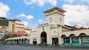 A building with a clock tower and a sign that reads "CHO BEN THAM". - Spring House Hotel (Ho Chi Minh City)