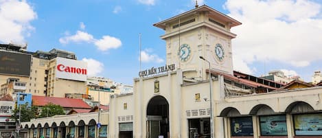 A building with a clock tower and a sign that reads "CHO BEN THAM".