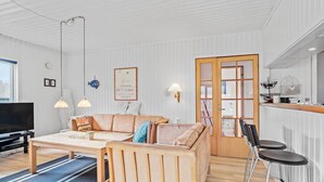 A living room with a sofa, coffee table, TV, and bar stools. - Nice home in Børkop with Wi-Fi (Børkop)