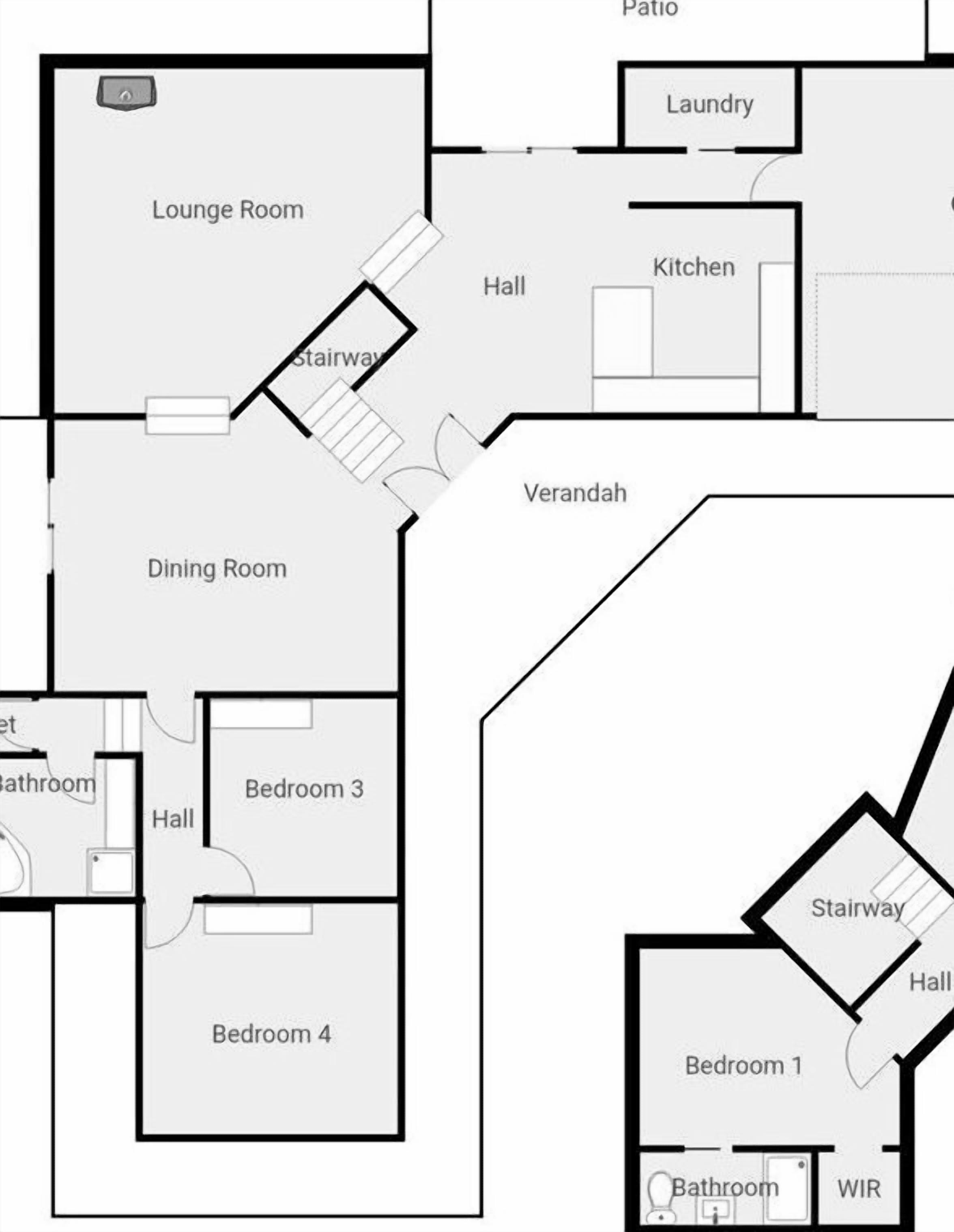 Een plattegrond met een salon, eetkamer, keuken, wasruimte en twee slaapkamers.