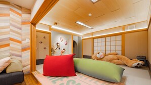 A traditional Japanese-style room with tatami flooring, a futon bed, and a low wooden table. - THE BLAUBAUM TOYA (Toyako)