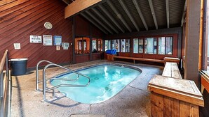 A hot tub area with a wooden ceiling, a pool, and wooden benches. - Remodeled Condo w/ View & Near Gondola 590 (Mammoth Lakes)