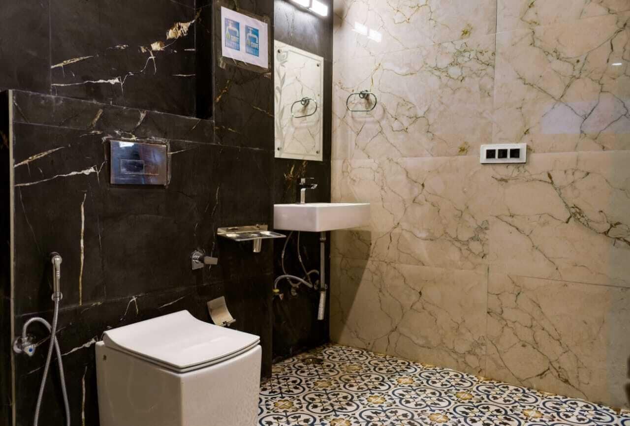 A bathroom with a toilet, sink, and shower.