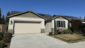 A single-story house with a garage, a well-maintained lawn, and a welcome sign. - New 3B Home / near Sequoia, EV, +More (Visalia)