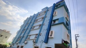 A multi-story hotel with a blue and white facade, multiple balconies, and visible air conditioning units. - Hotel Jayadeep  (Bhubaneshwar)