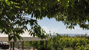 A patio with lounge chairs, a table, and a pergola. - Room-camagna Country House Scopello Room (Partanna)
