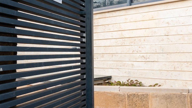 A modern building entrance with a sign reading "Unit Misgav" and a view of the sky through large windows. - Huge & Lovely Unit 2BR 2BT By the beach (Rishon LeTsiyon)