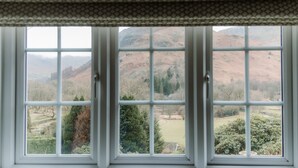 A window with a view of a valley and hills. - Grey Walls (Penrith)