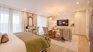 A hotel room with a large bed, a desk, a chair, a television, and a wardrobe. - The Weinberg Urban Pods (Windhoek)