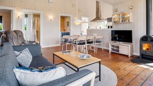 A spacious living area with a sofa, coffee table, and a fireplace.