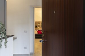 Enter a clean and functional living space with a comfortable sofa and a touch of greenery.