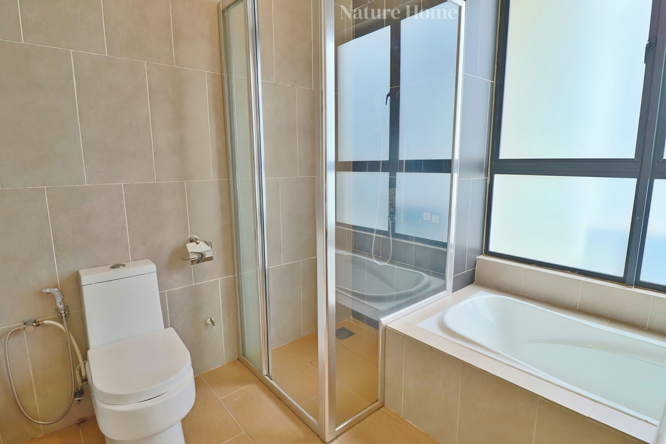 A modern bathroom with a toilet, shower, and bathtub.