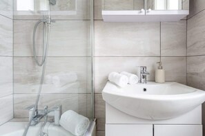 Shower, hair dryer, towels, shampoo