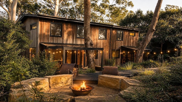 A wooden cabin with a fire pit, outdoor seating, and string lights. - Architect design home, walk to Macmasters Beach (MACMASTERS BEACH)