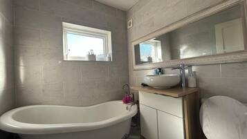 Combined shower/bathtub, deep-soaking bathtub, towels