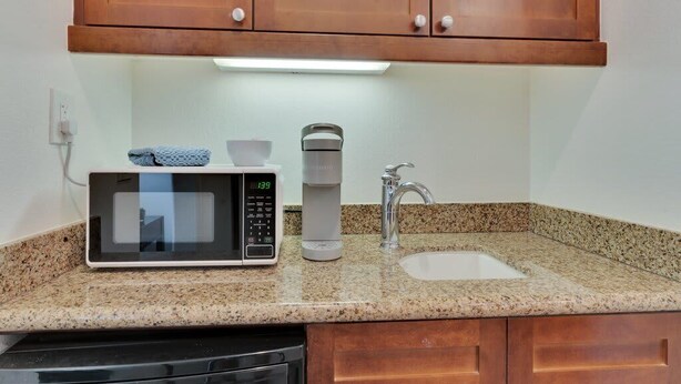 A kitchen with a microwave, coffee maker, and sink. - Desert Haven B | Studio Legacy Villa (La Quinta)