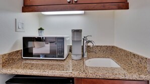 A kitchen with a microwave, coffee maker, and sink. - Desert Haven C | Studio Legacy Villa (La Quinta)