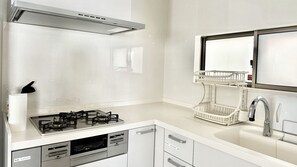 A modern kitchen with a gas stove, dishwasher, and a built-in oven.